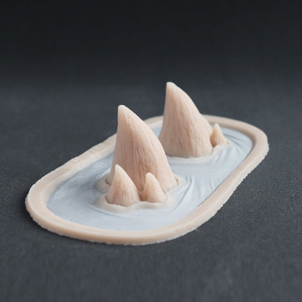 Triple Devil Horns - Silicone makeup prosthetic in vanilla shade on a black surface