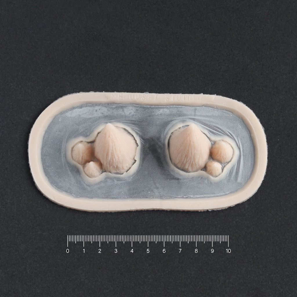 Triple Devil Horns - Silicone makeup prosthetic in vanilla shade on a black surface with a ruler