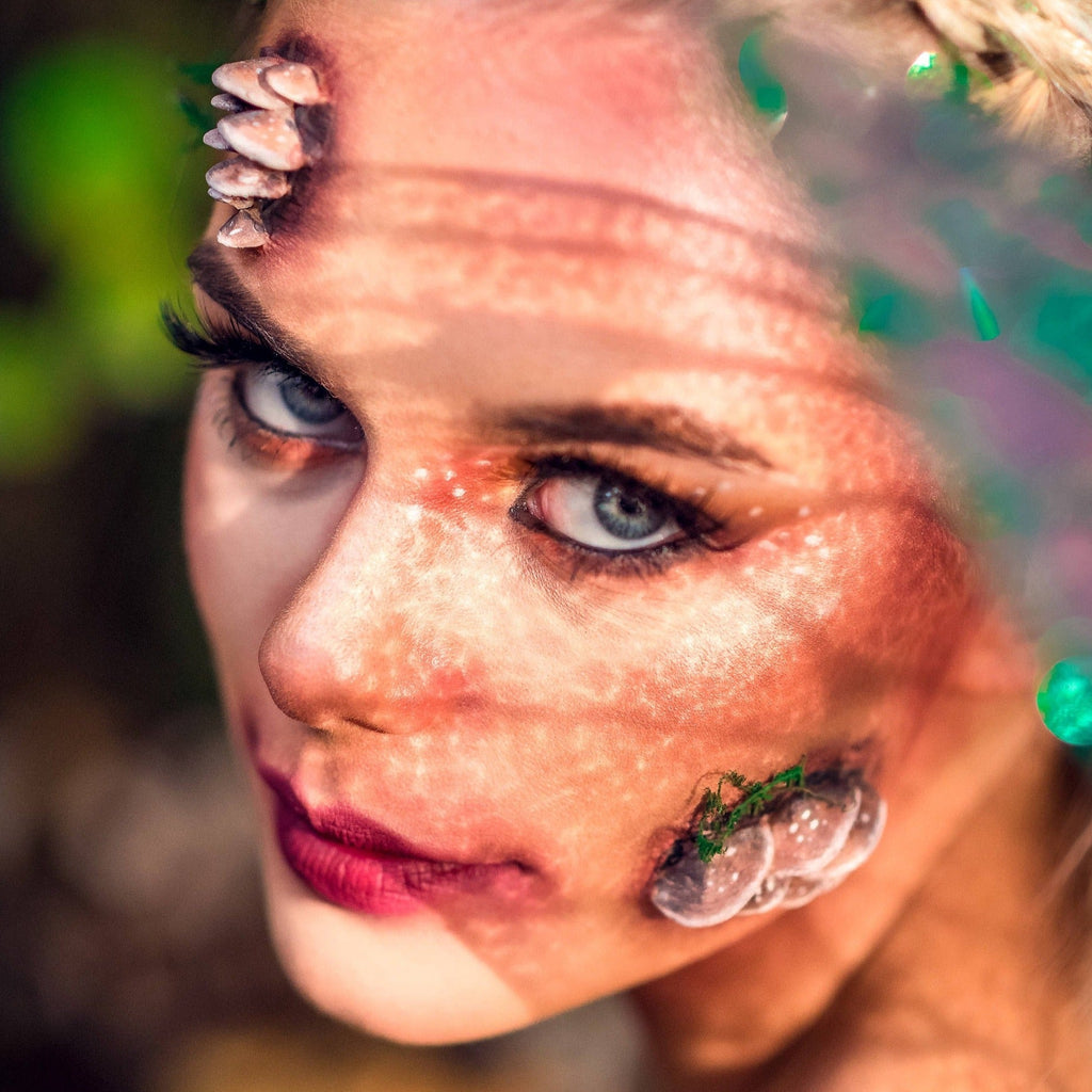 Blond woman with fungi prosthetics on her face