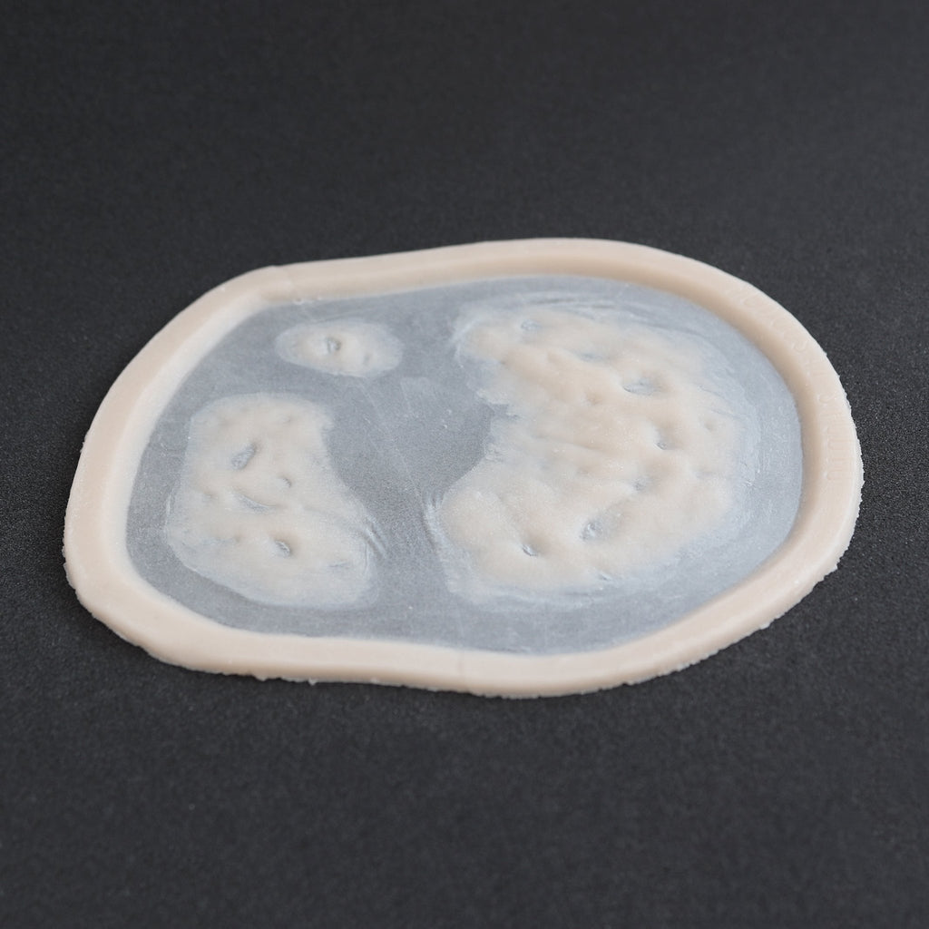 Zombie Bite 2.0 - Silicone makeup prosthetic in vanilla shade on a black surface