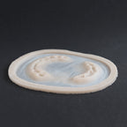 Zombie Bite - Silicone makeup prosthetic in vanilla shade on a black surface